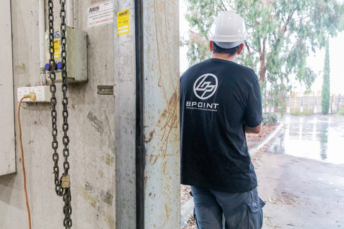 Bpoint technician inspecting an alarm installation at a commercial site