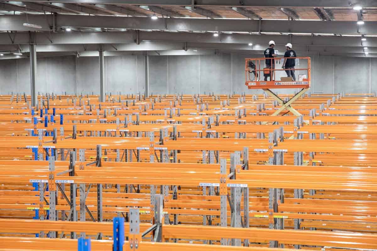 Bpoint technicians on scissor lift in aisles