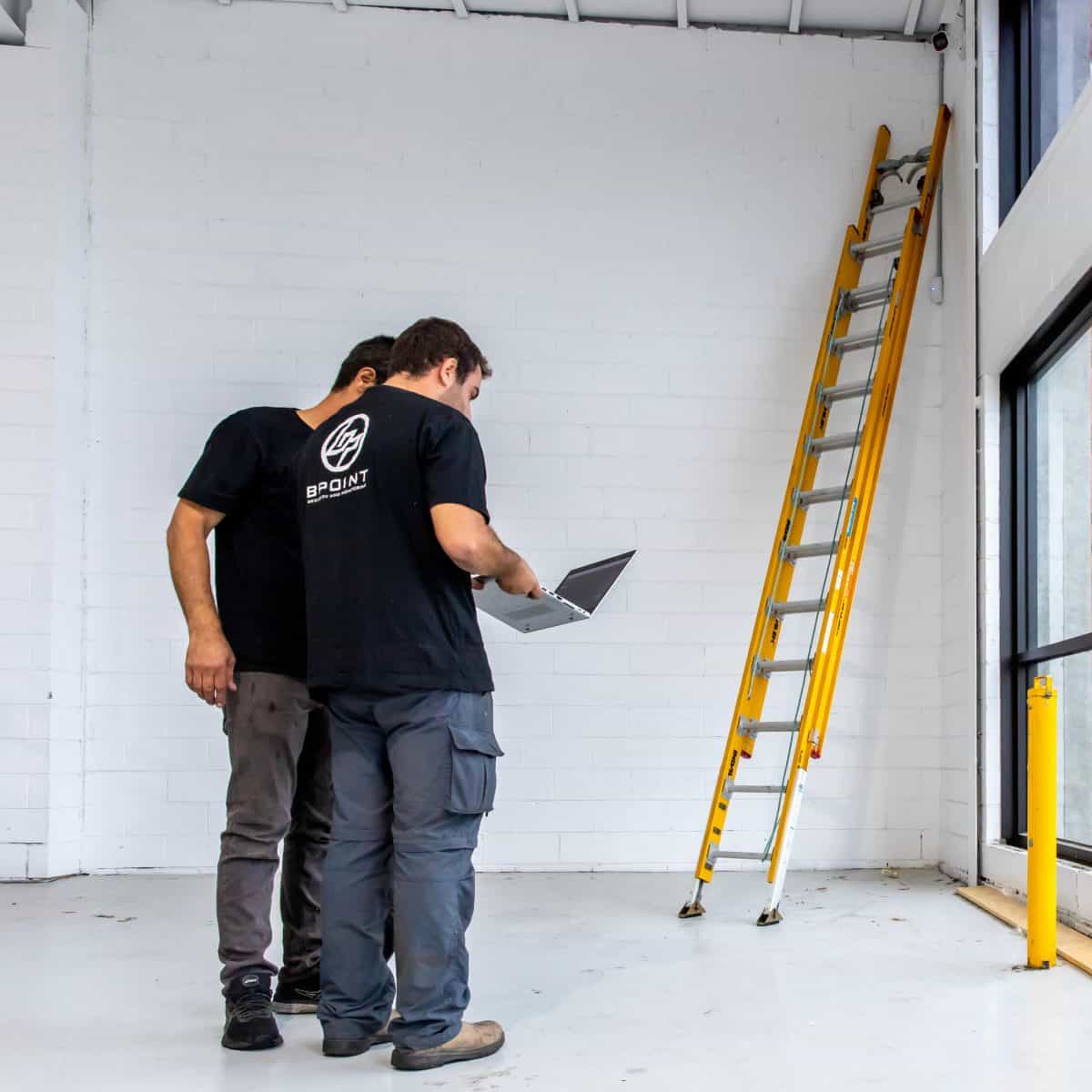 Bpoint technicians planning an installation on a laptop at a commercial site
