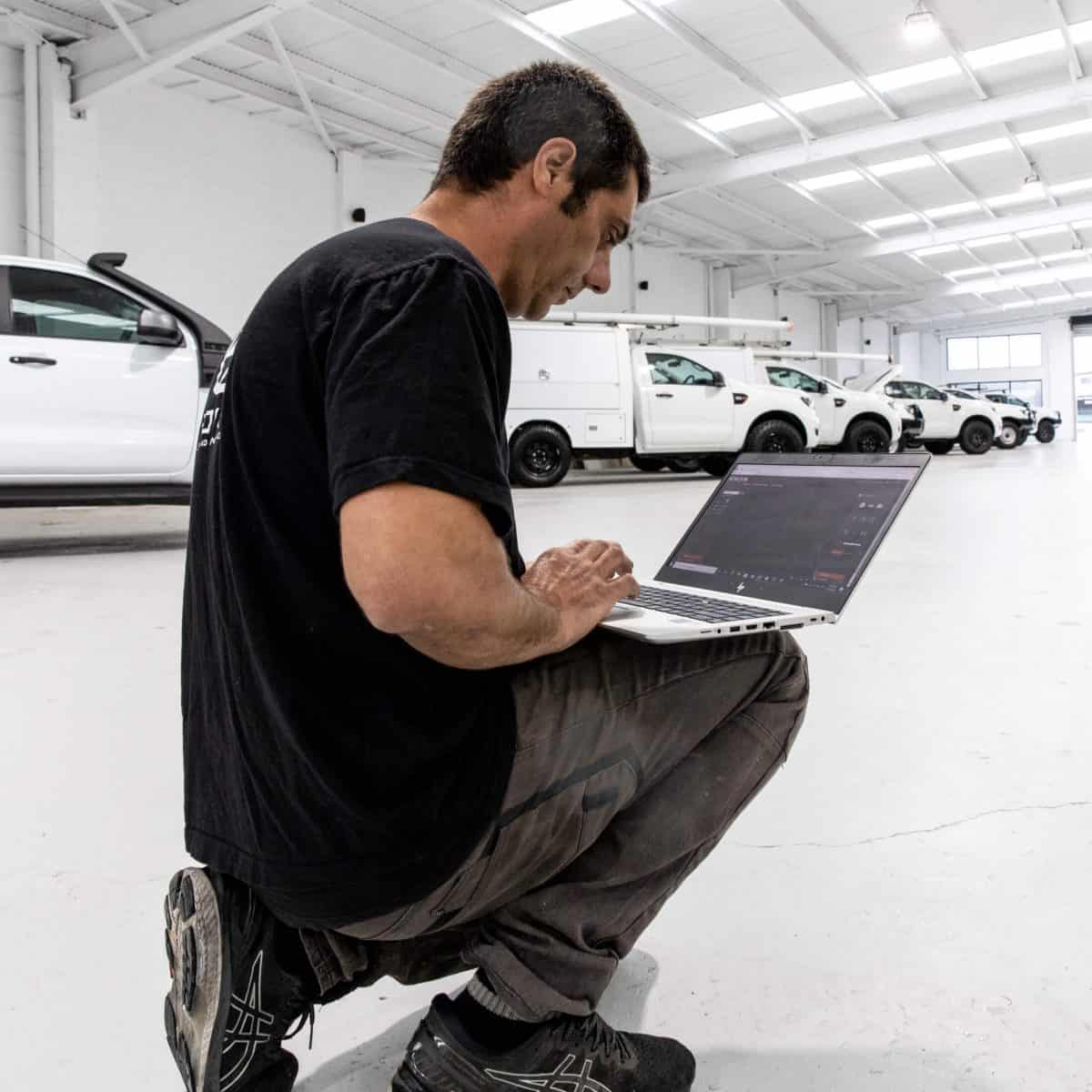 Bpoint technician commissioning a camera system on a laptop