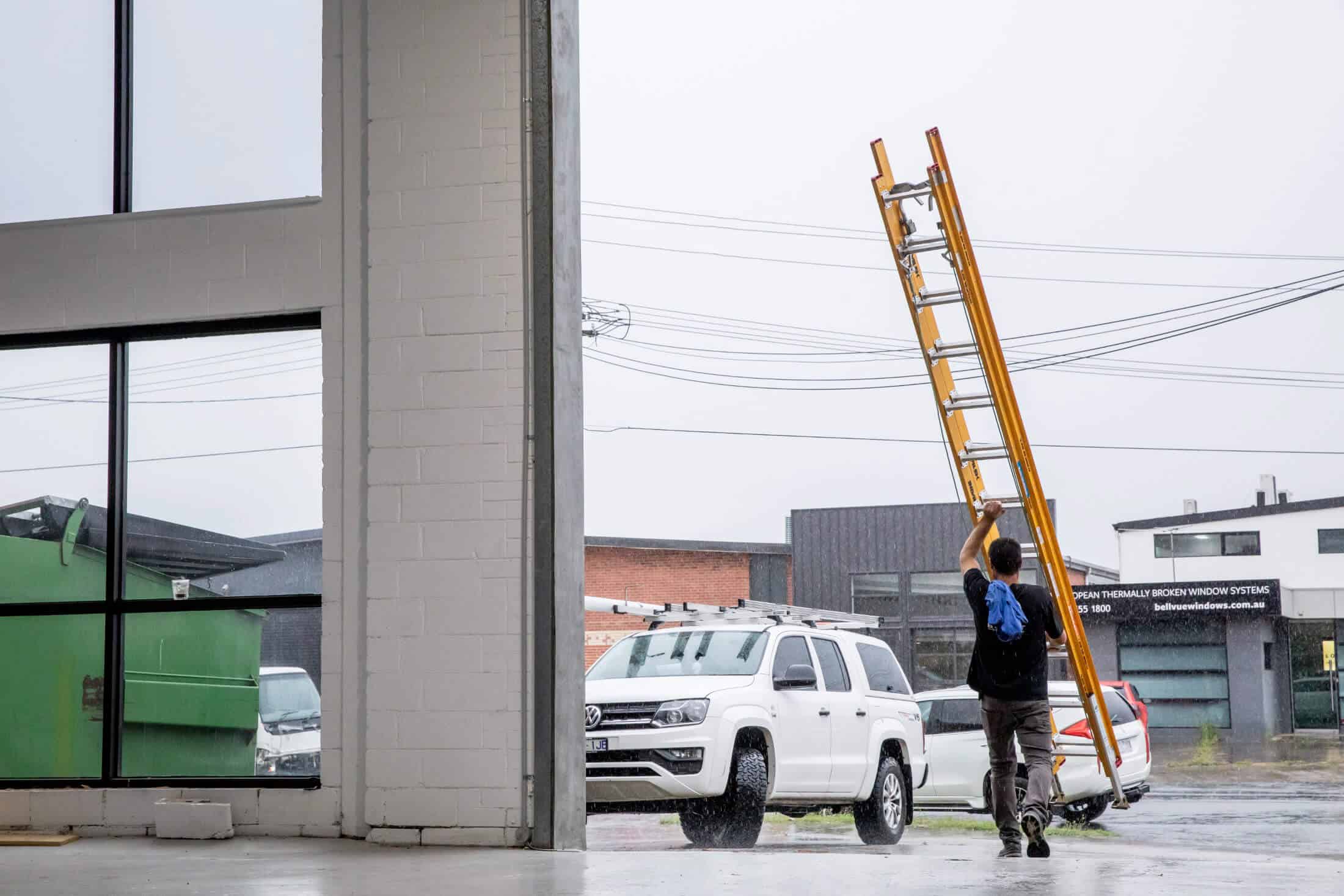 Man holding a yellow ladder