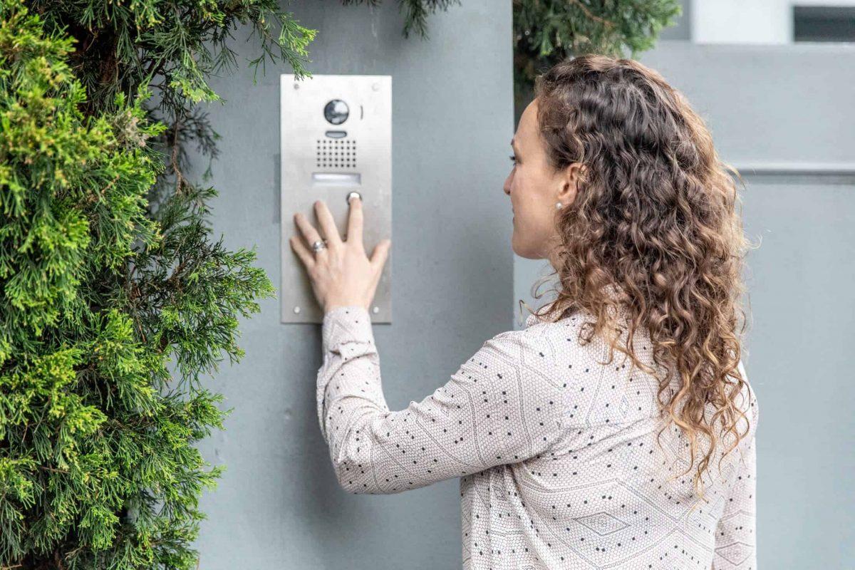 Woman pressing AIPHONE