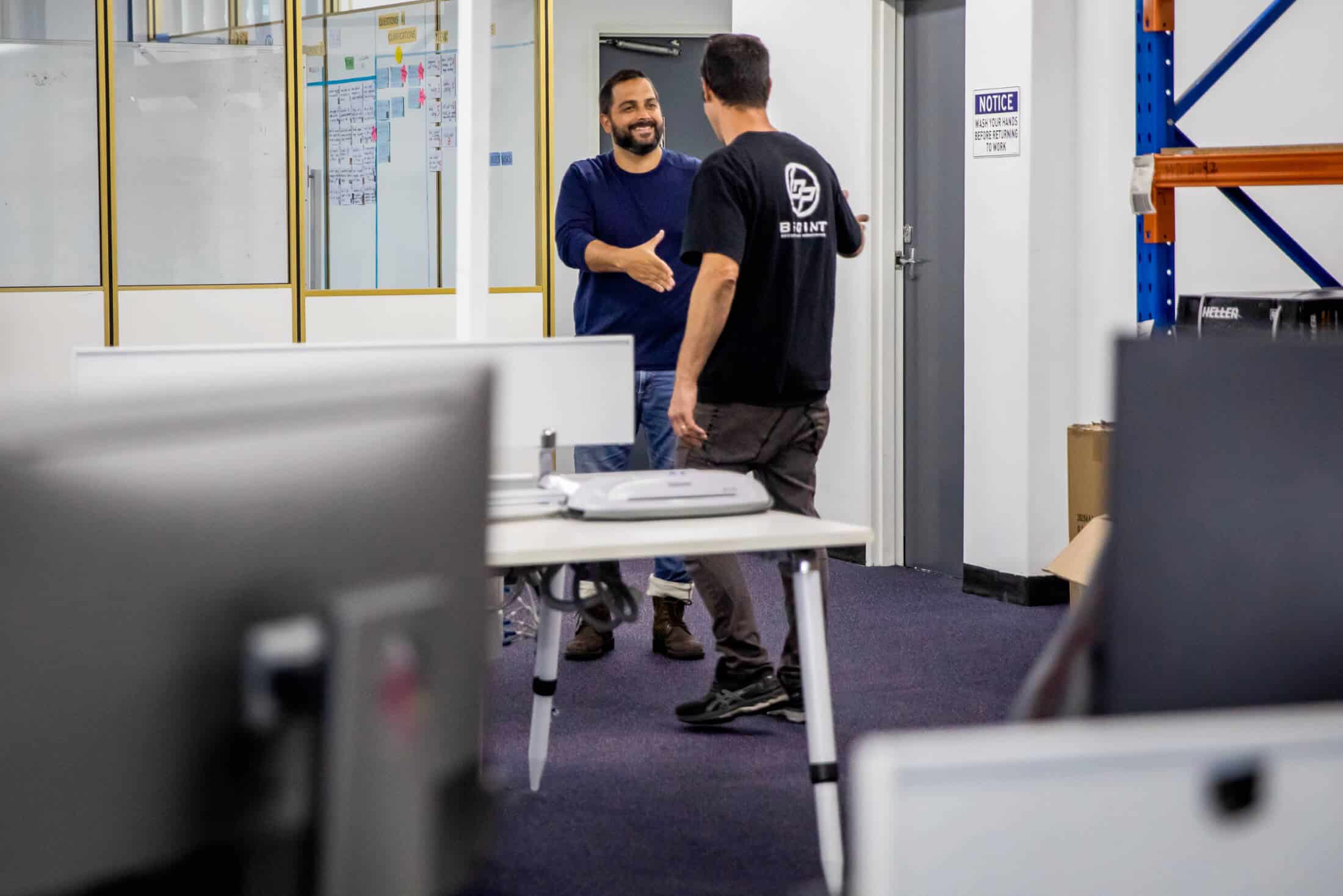 Bpoint technician meeting a business owner in a warehouse office