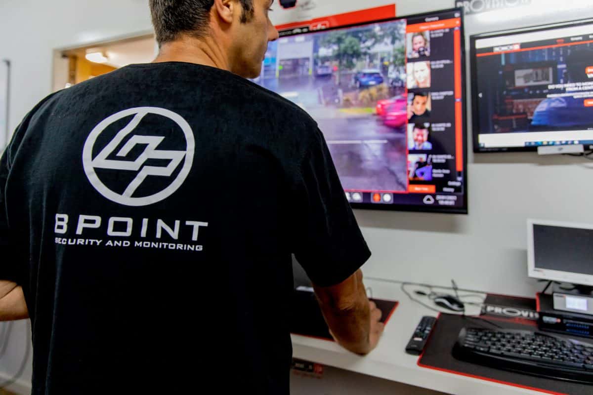 Bpoint technician operating video management software across several screens